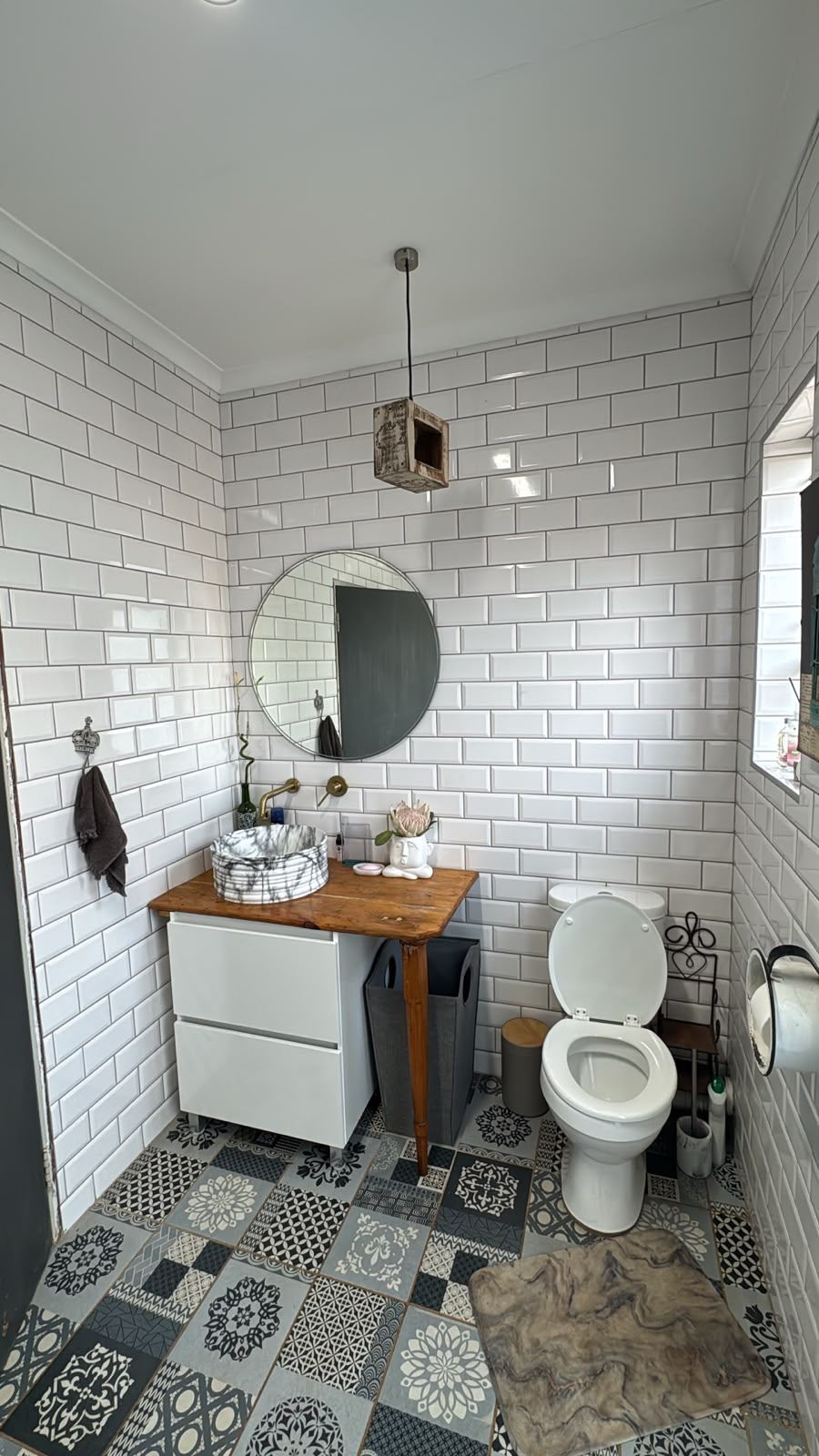 Renovated bathroom with subway tiles and vessel basin