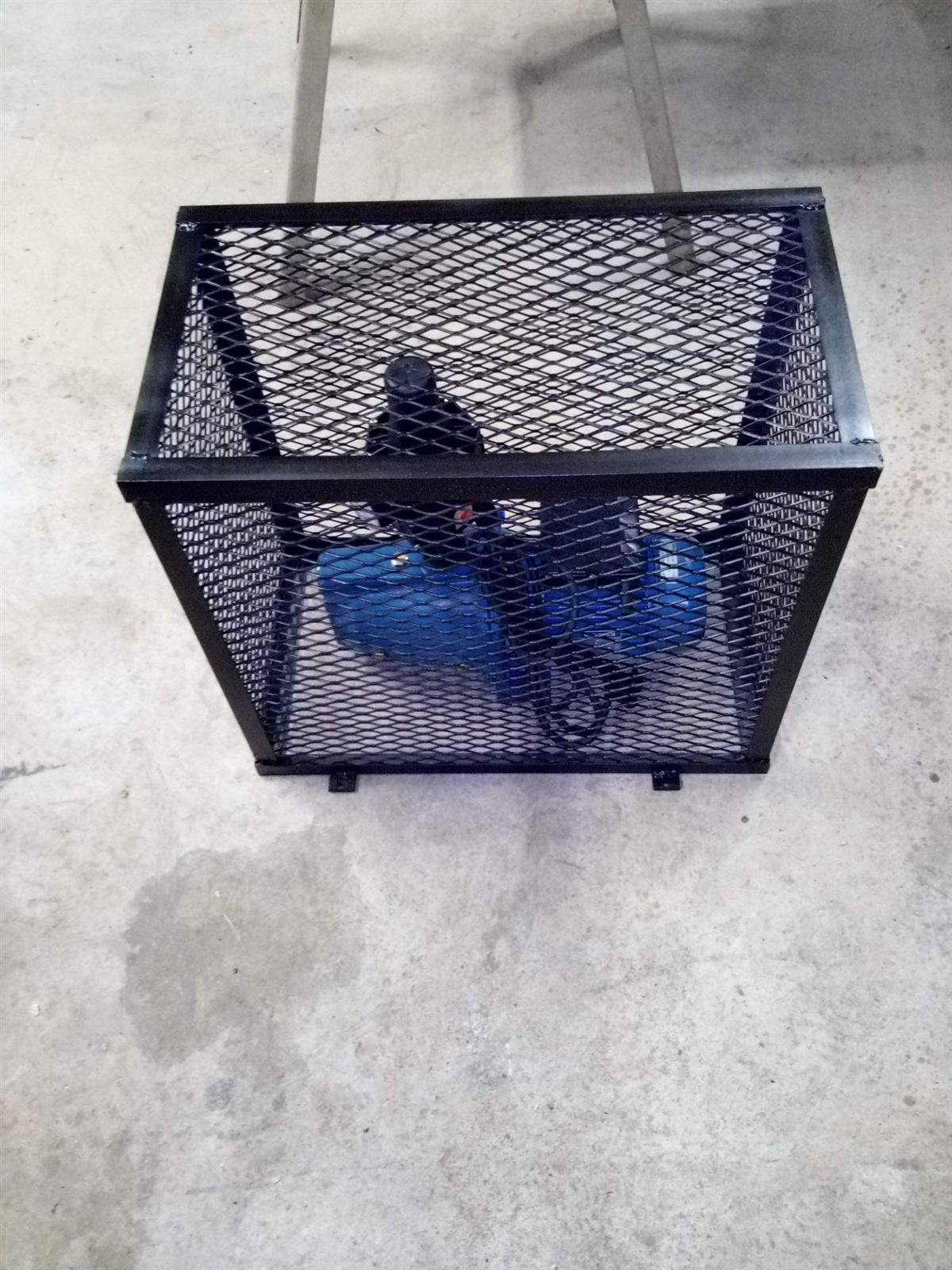 Booster pump inside a steel mesh security cage